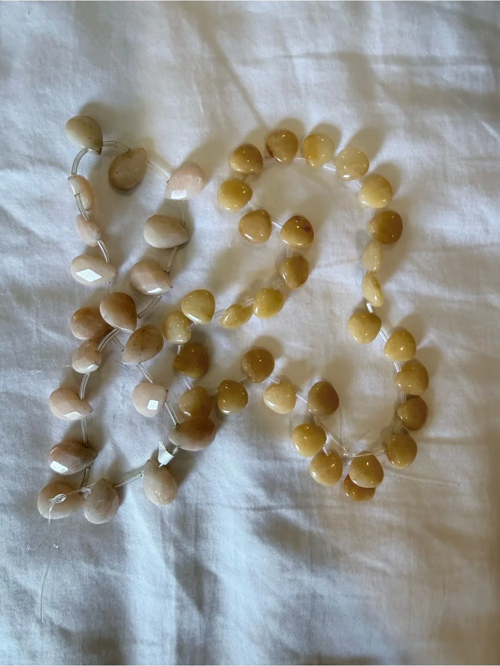 Two strands of taupe/cream/ivory colored stones
